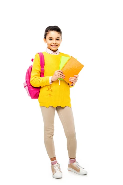 Adorable kid with backpack looking at camera isolated on white — Stock Photo