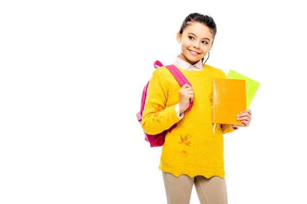 Adorable child with backpack holding books and smiling isolated on white — Stock Photo