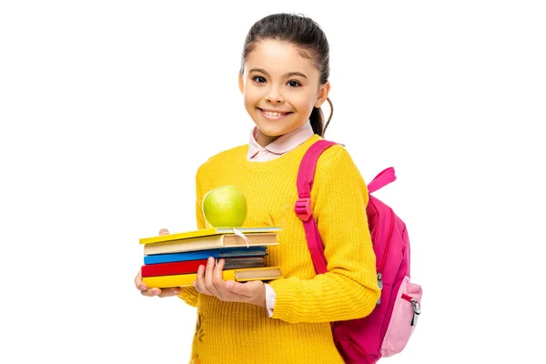 Adorabile scolaro in possesso di libri e mela isolato su bianco — Foto stock