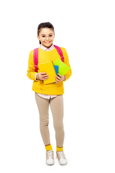 Entzückendes Schulkind mit Brille, Bücher in der Hand und isoliert auf weißem Grund lächelnd — Stockfoto