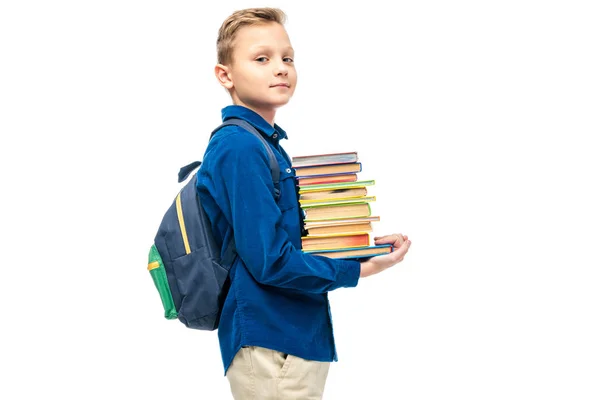 Mignon garçon tenant pile de livres et regardant caméra isolé sur blanc — Photo de stock