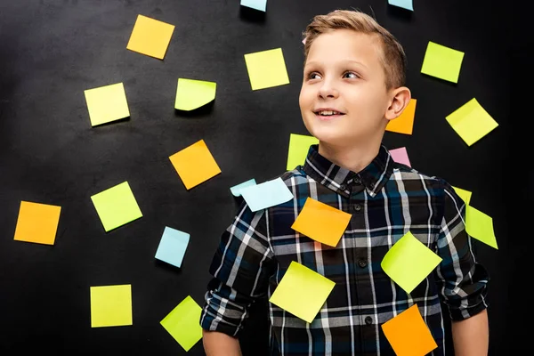 Menino bonito com adesivos multicoloridos no fundo preto — Fotografia de Stock