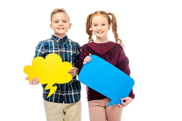 Smiling kids standing, holding multicolored speech bubbles and looking at camera isolated on white — Stock Photo