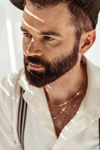 Thoughtful bearded man in casual clothing with golden chain — Stock Photo