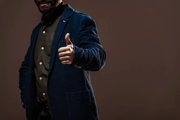 Cropped view of man showing thumb up isolated on brown — Stock Photo