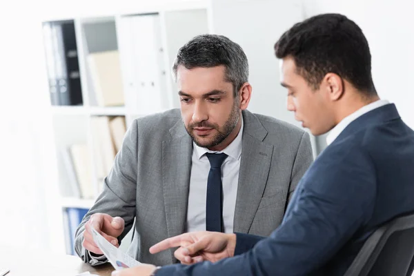 Two concentrated professional businessmen working with papers in office — Stock Photo