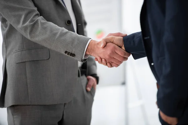 Plan recadré d'hommes d'affaires en tenue formelle serrant la main au bureau — Photo de stock