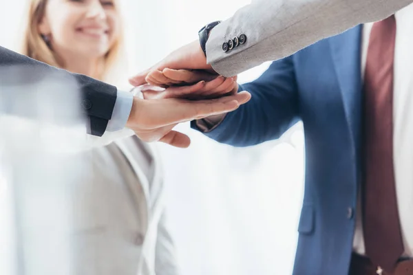 Cropped shot of professional business people stacking hands together — Stock Photo