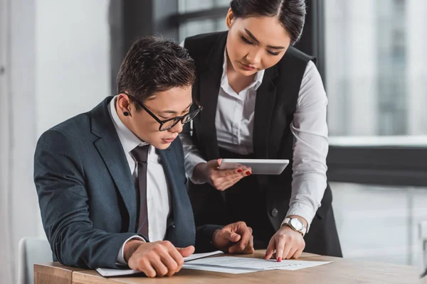 Professional kazakh business people working with contract and tablet computer in office — Stock Photo