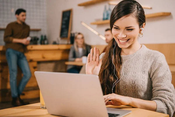 Selective focus of cheerful woman having video chat in cafe — Stock Photo