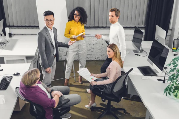 High angle view of multiethnic young businesspeople working together in office — Stock Photo