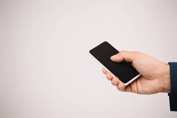 Cropped view of businessman using smartphone isolated on grey — Stock Photo