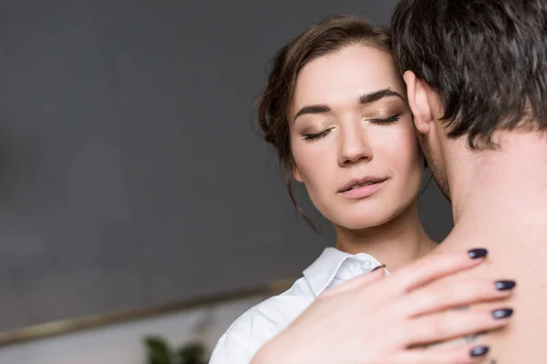 Young girl enjoying by gentle touch of guy with closed eyes — Stock Photo