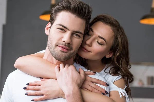 Close up of attractive woman with closed eyes embracing man — Stock Photo