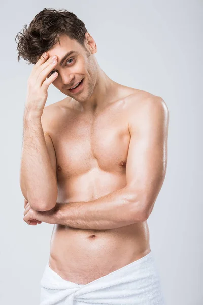 Handsome sexy man posing in towel isolated on grey — Stock Photo