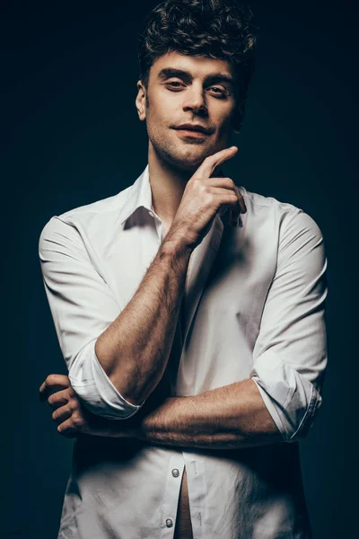 Stylish sexy man posing in white shirt isolated on dark grey — Stock Photo