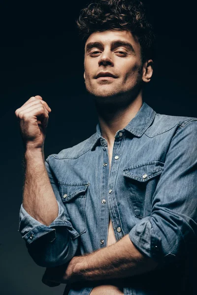 Handsome smiling man posing in denim clothes isolated on grey — Stock Photo