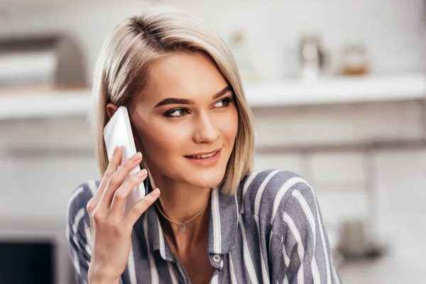 Selective focus of attractive woman talking on smartphone — Stock Photo
