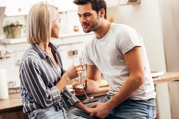Handsome boyfriend and girlfriend holding wine glasses — Stock Photo