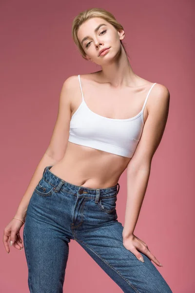 Beautiful slim woman posing in white bra, isolated on pink — Stock Photo