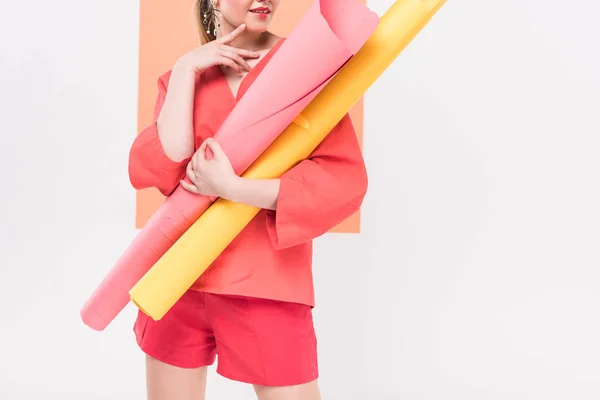 Cropped view of girl holding paper rolls and posing with copy space and living coral on background — Stock Photo