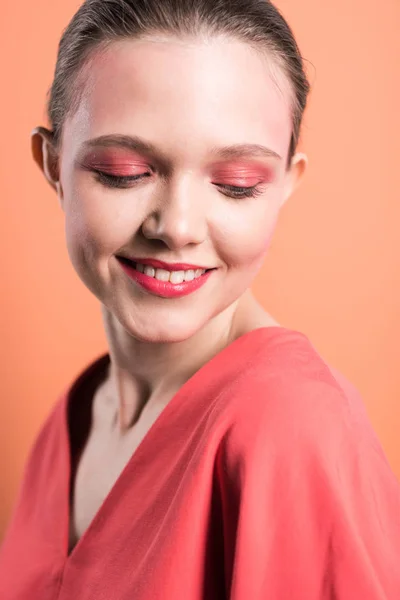 Portrait of beautiful stylish girl smiling and posing isolated on living coral — Stock Photo