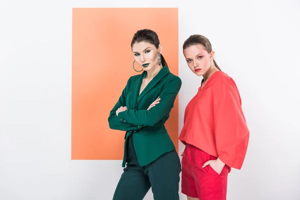 Beautiful fashionable young women looking at camera and posing with living coral on background — Stock Photo