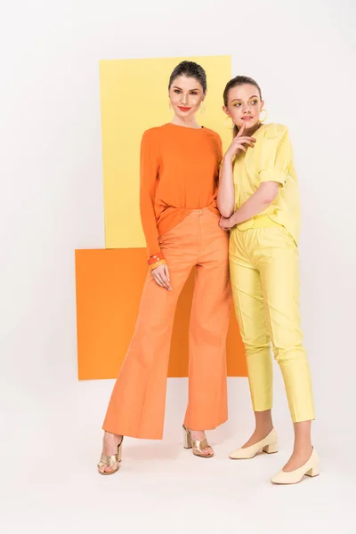 Beautiful stylish young women posing with turmeric and limelight on background — Stock Photo