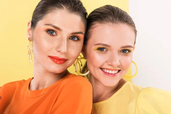 Attractive stylish girls posing with limelight on background — Stock Photo