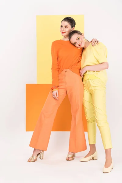 Beautiful stylish girls posing with turmeric and limelight on background — Stock Photo