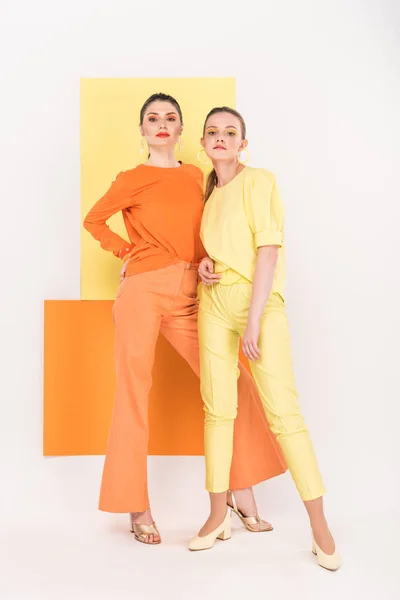 Confident stylish girls posing with turmeric and limelight on background — Stock Photo