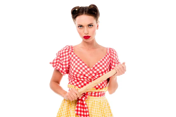 Serious young pin up girl holding rolling pin isolated on white — Stock Photo