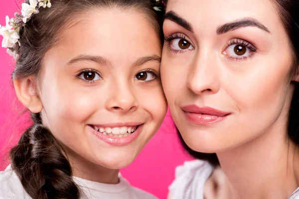 Close-up retrato de bela mãe feliz e filha sorrindo para a câmera isolada em rosa — Fotografia de Stock