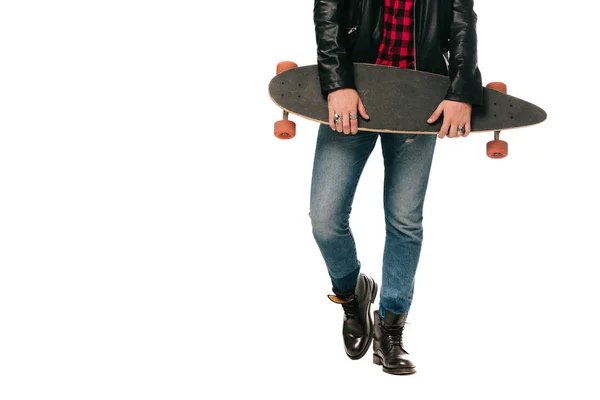 Low section view of skateboarder posing with longboard isolated on white — Stock Photo