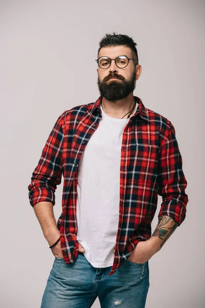 Confident bearded man posing in checkered shirt isolated on grey — Stock Photo