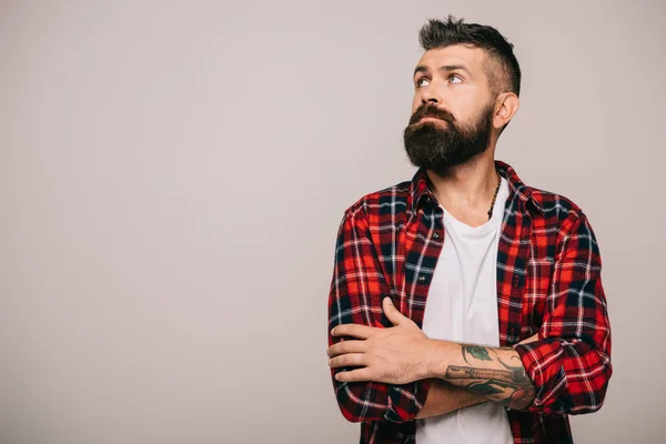 Thoughtful bearded man in checkered shirt isolated on grey — Stock Photo