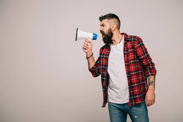 Angry handsome man shouting into megaphone, isolated on grey — Stock Photo