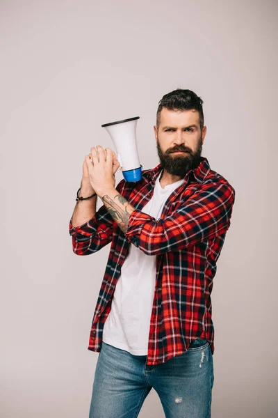 Handsome bearded man holding megaphone, isolated on grey — Stock Photo