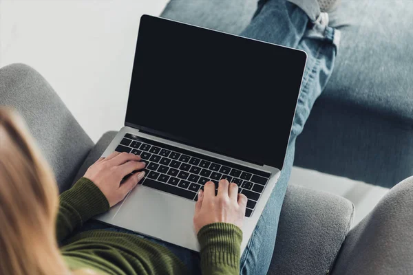 Cropped view of woman using laptop with blank screen — Stock Photo