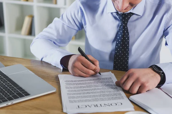 Cropped view of man signing contract on office — Stock Photo