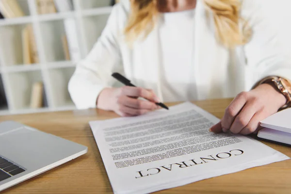 Cropped view of woman holding pen near contract — Stock Photo