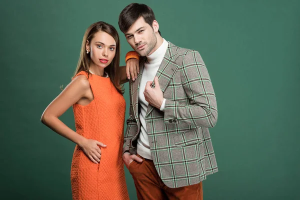 Beautiful woman embracing handsome man in vintage clothes isolated on green — Stock Photo