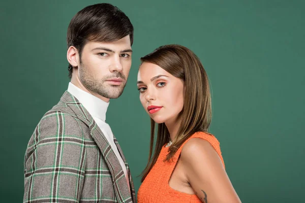 Beautiful couple in vintage clothes posing isolated on green — Stock Photo