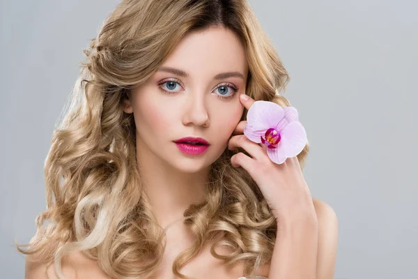 Young nude attractive woman holding purple orchid near face isolated on grey — Stock Photo