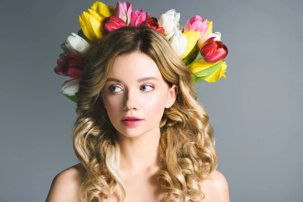 Beautiful girl with wreath of flowers on hair isolated on grey — Stock Photo