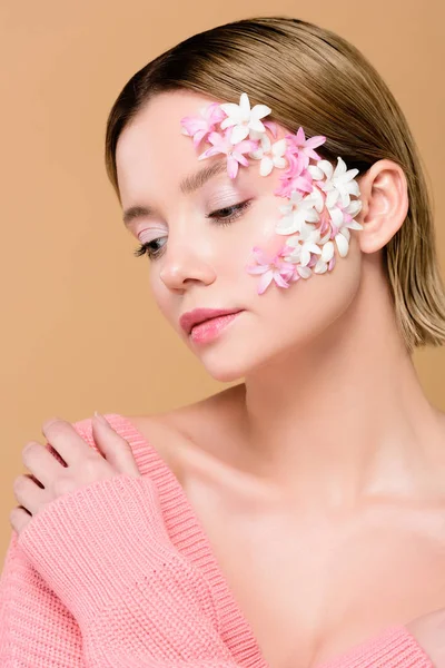Tender woman with flowers on face isolated on beige — Stock Photo