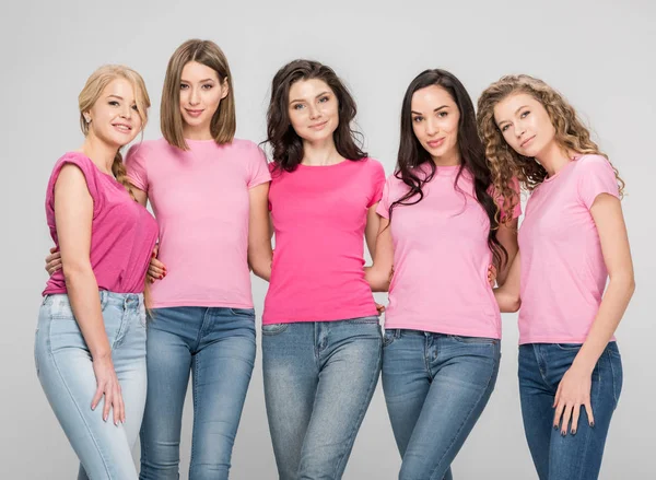 Attractive women standing together isolated on grey — Stock Photo