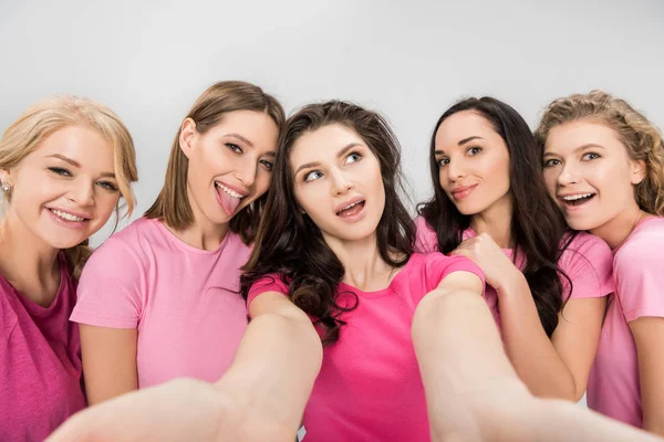 Funny young women taking selfie and smiling isolated on grey — Stock Photo