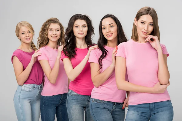 Happy young women standing together isolated on grey — Stock Photo