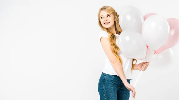 Happy attractive woman holding pink and white air balloons on white background with copy space — Stock Photo